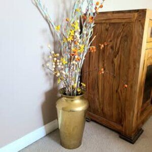 Large brass floor vase for dry flowers.